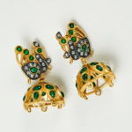 Gold plated finish Peacock inspired detailing with green stones.